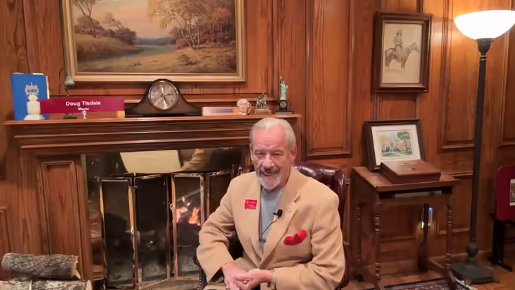 Doug seated beside the fireplace for his third Fireside Chat