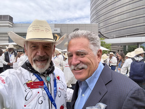 Doug Tisdale with community supporters at an outdoor event